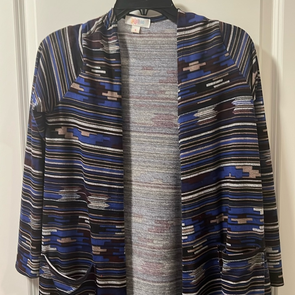 Lularoe long cardigan with pockets size small. Blues, blacks with design.